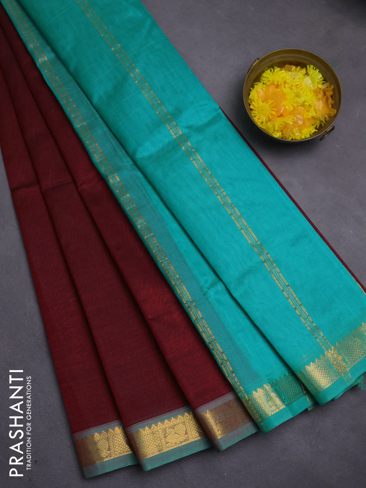 Silk cotton saree deep maroon and teal green with plain body and zari woven border