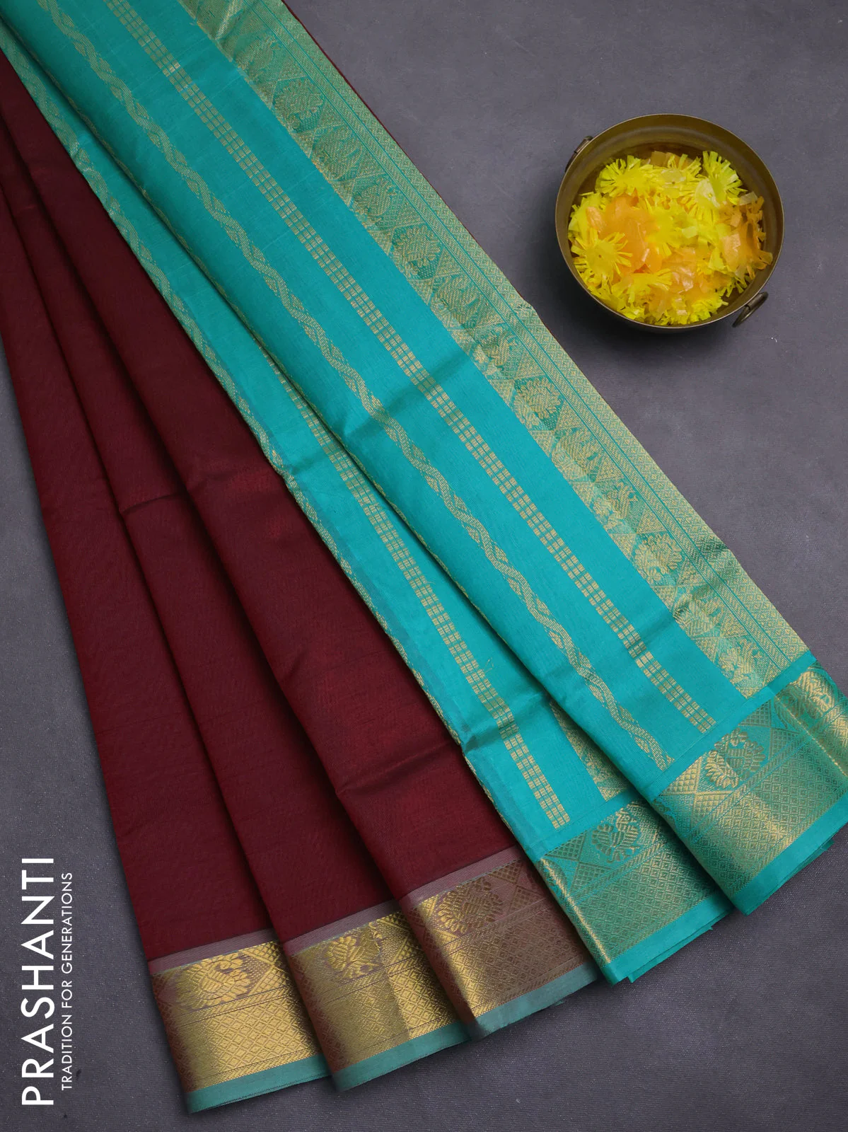 Silk cotton saree deep maroon and teal green with plain body and zari woven border