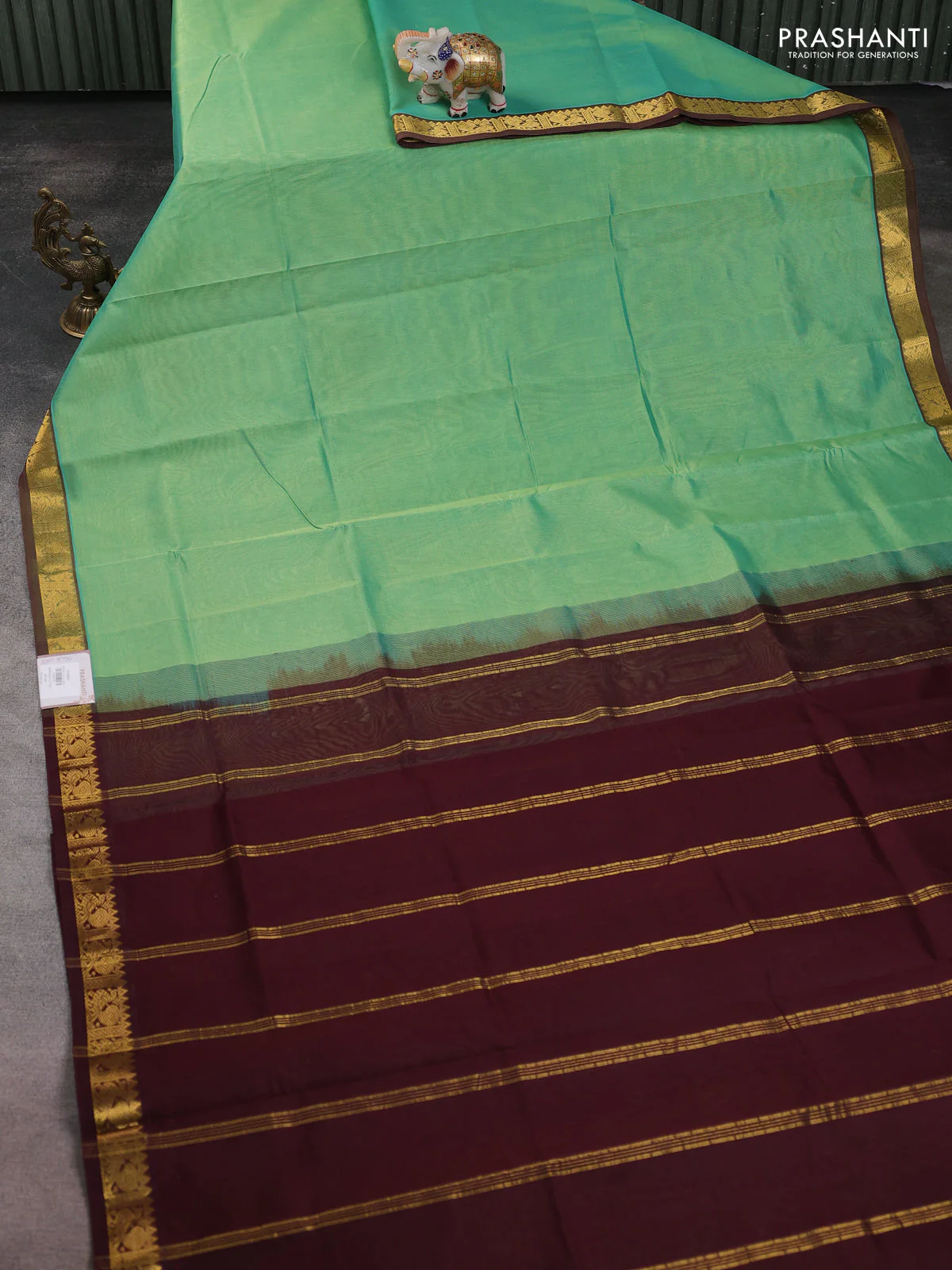 Silk cotton saree metallic green and coffee brown with plain body and zari woven border - Image 2