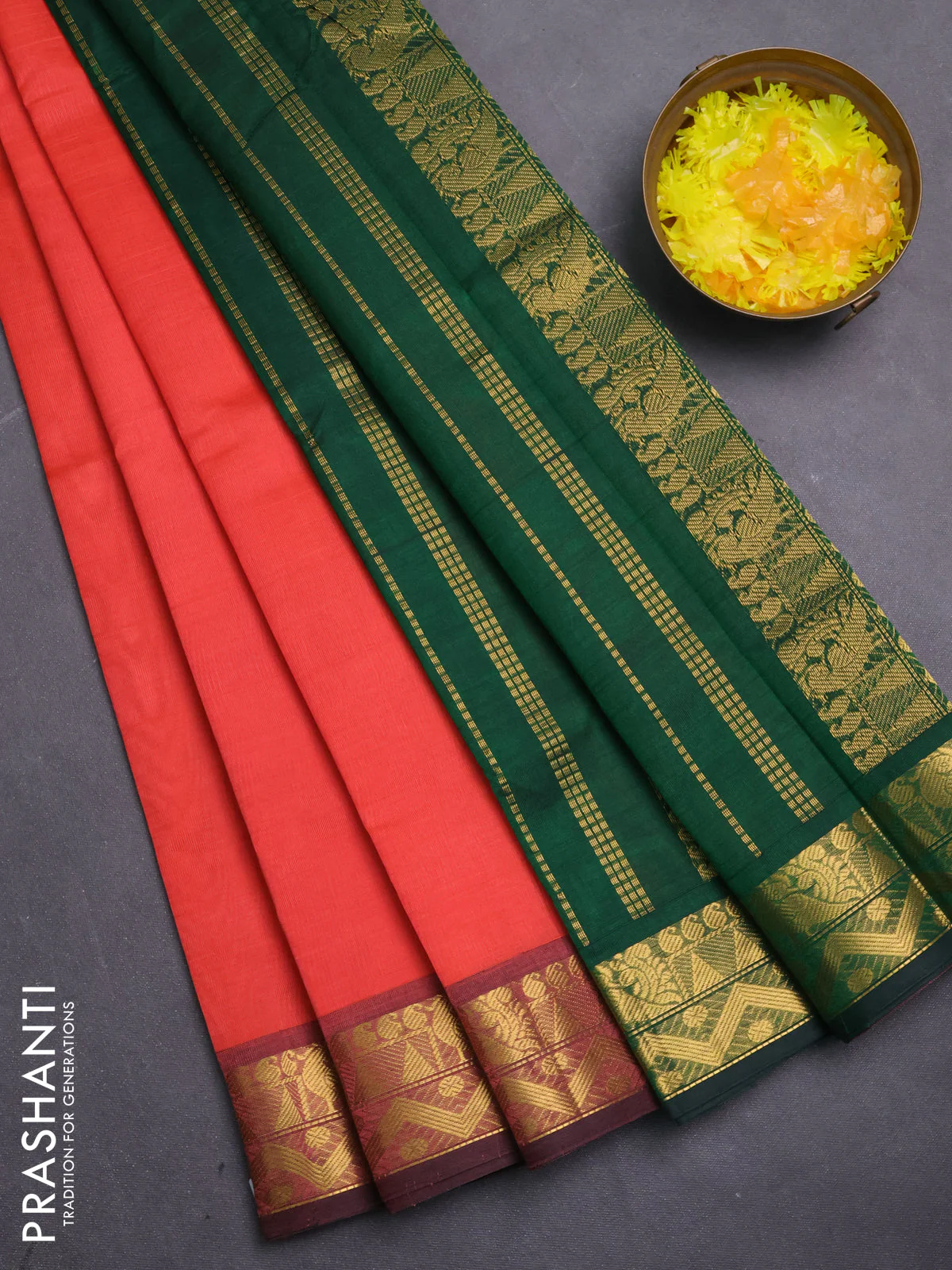 Silk cotton saree peach shade and bottle green with plain body and zari woven border