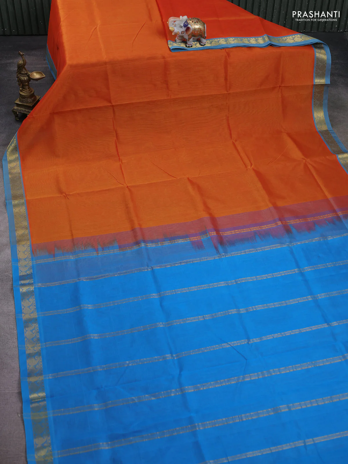 Silk cotton saree sunset orange and cs blue with plain body and paisley zari woven border - Image 2
