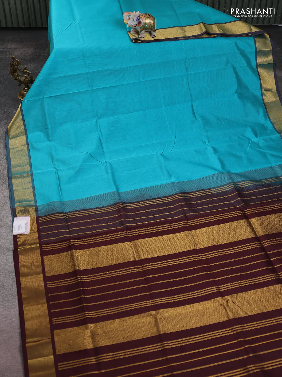 Silk cotton saree teal blue and coffee brown with plain body and zari woven border - Image 2