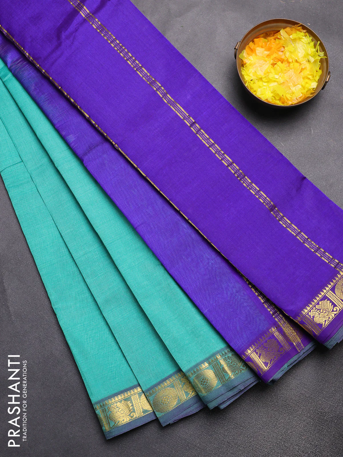 Silk cotton saree teal green and blue with plain body and zari woven border
