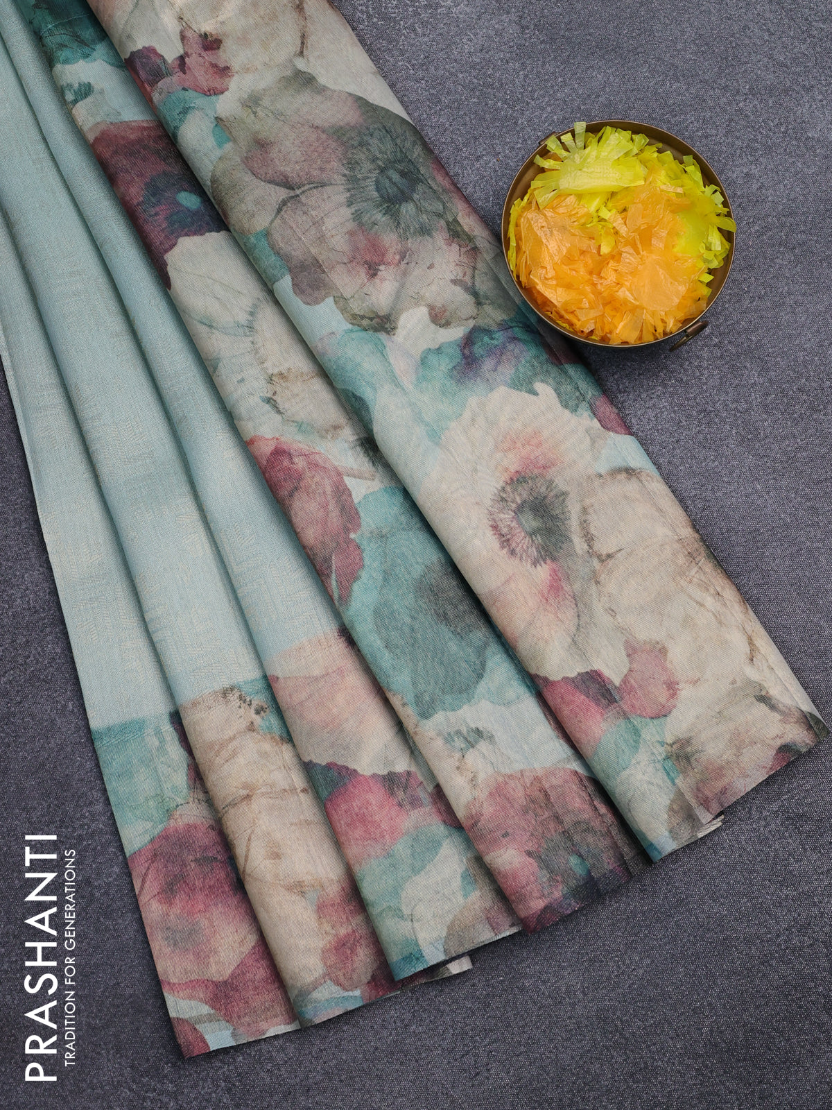 Tissue saree teal blue with allover zari weaves and floral digital printed border