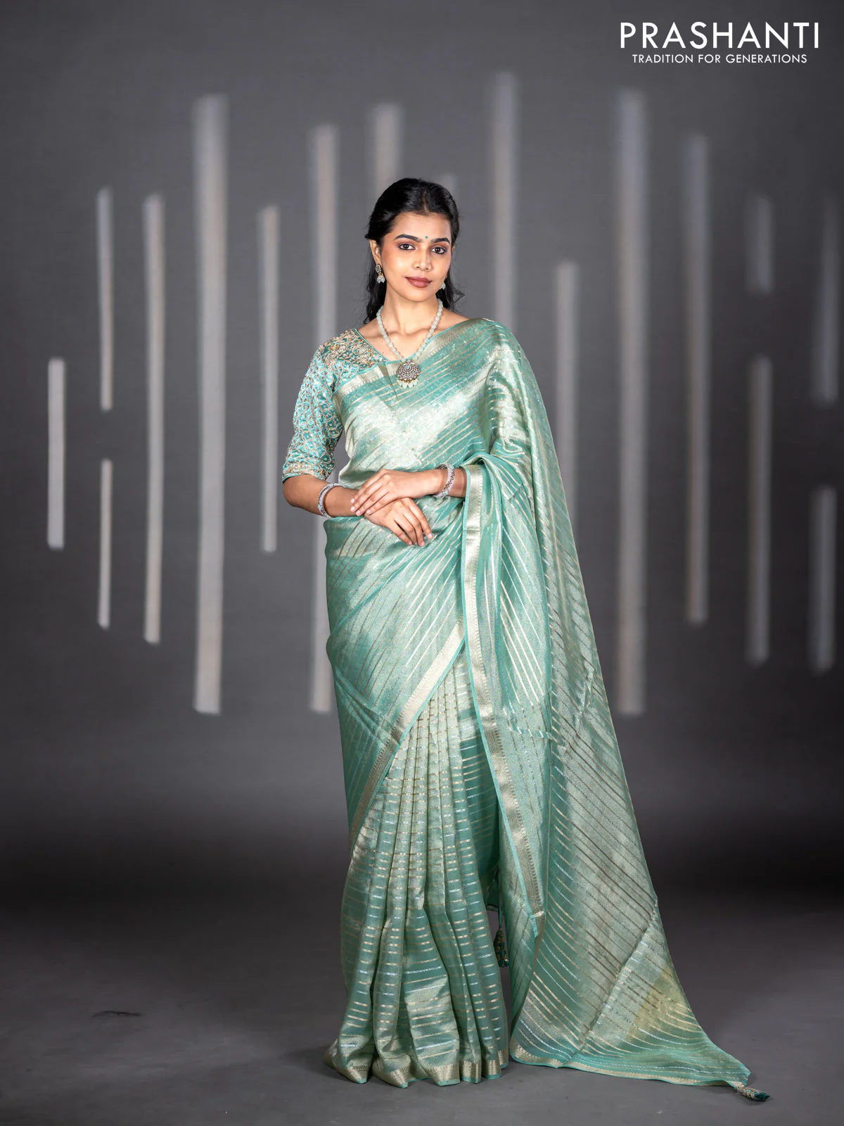 Tissue silk saree teal shade with allover silver & zari weaves and zari woven border