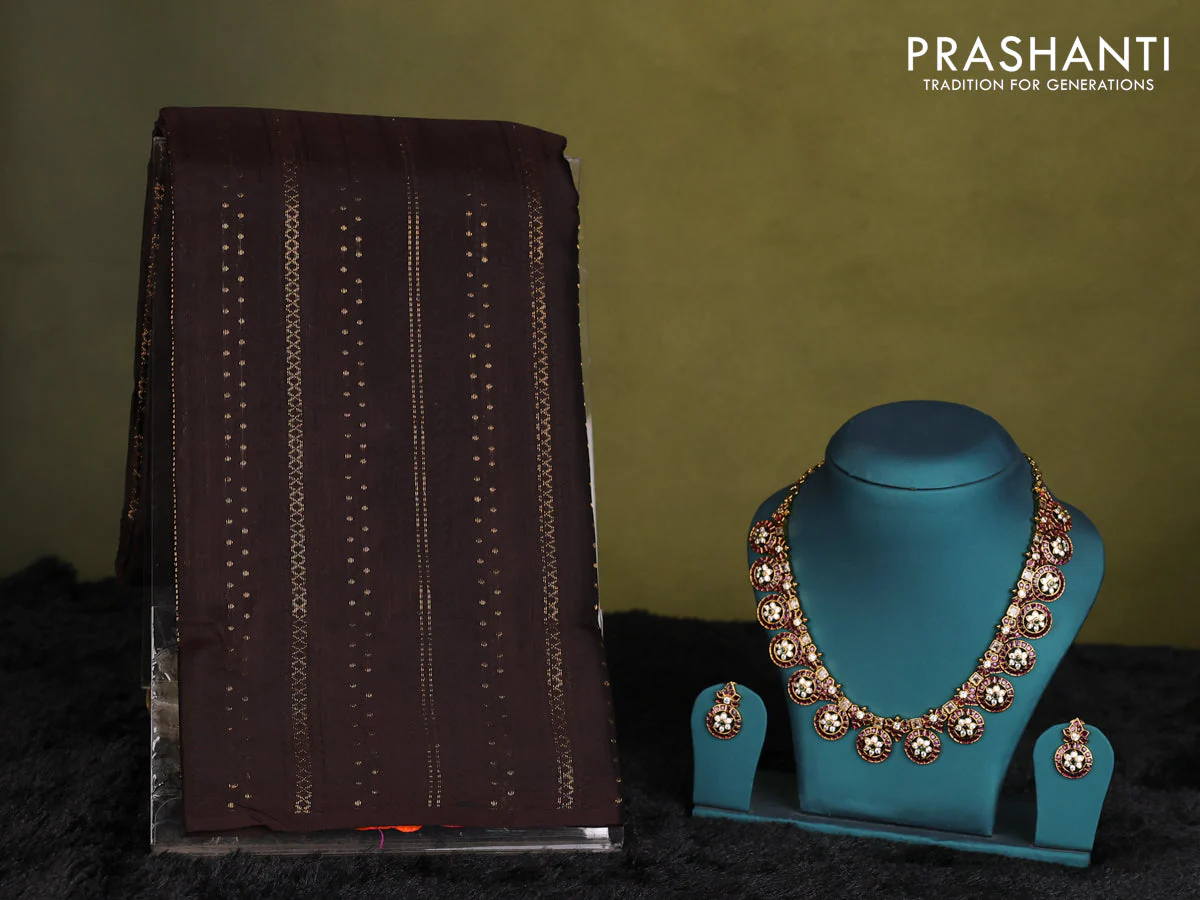 Wine shade Kanchipuram silk saree with matching antique necklace