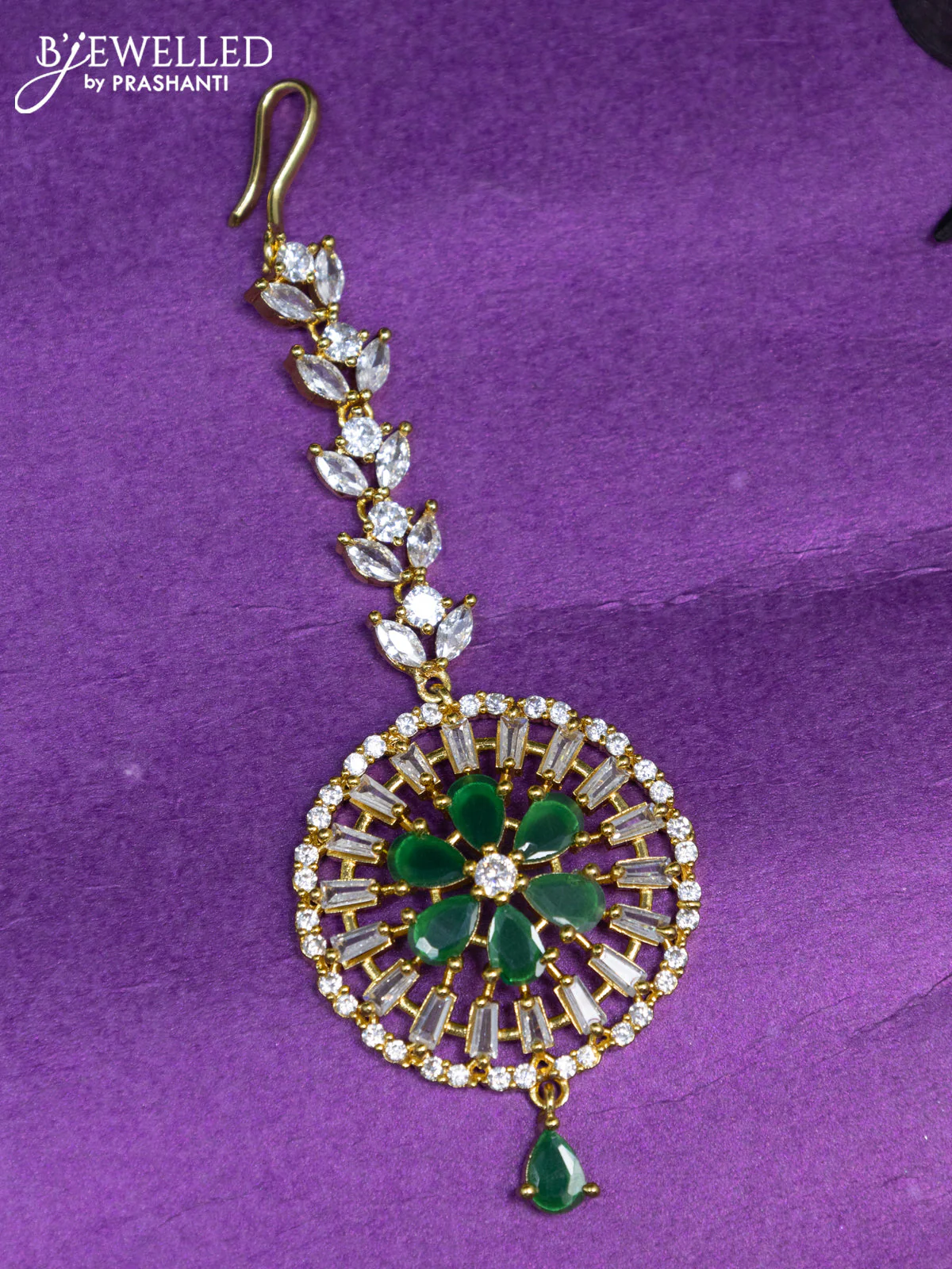 Zircon maang tikka with emerald & cz stones and hangings in gold finish