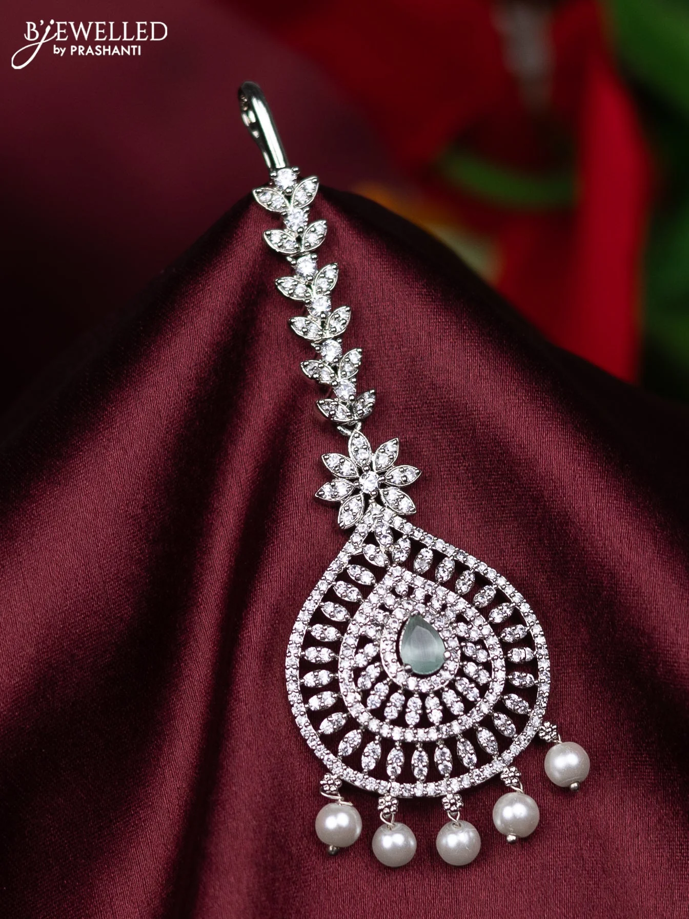 Zircon maang tikka with mint green & cz stones and pearl hanings